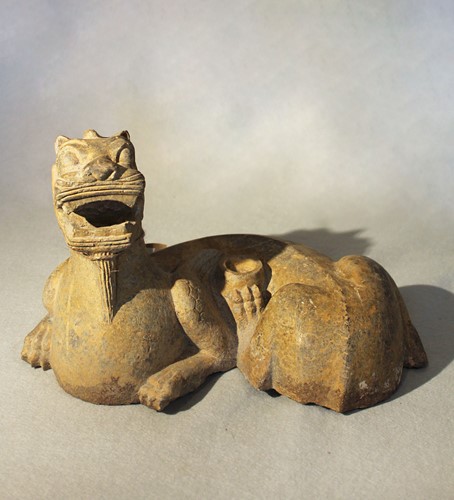 Lot 275 - A Chinese grey limestone figure of a recumbent Pixiu/Chimera, in Southern Qi style