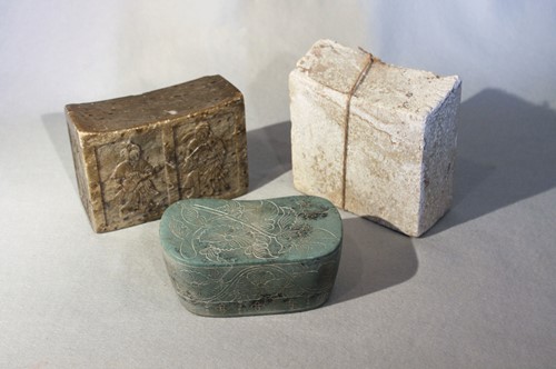 Lot 276 - Three Chinese pillows, green/brown puddingstone with musicians in relief