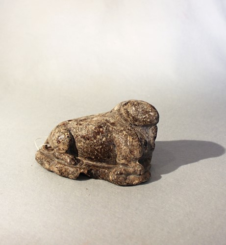 Lot 278 - A Chinese brown mottled stone recumbent figure of a cloven mythical creature, in Sui Dynasty style