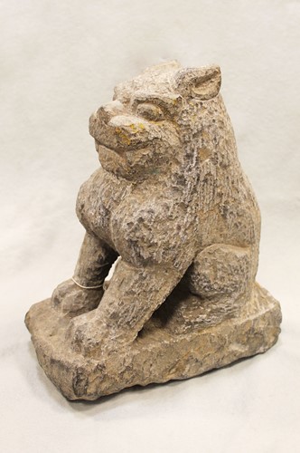 Lot 293 - A Chinese grey stone Buddhist guardian lion, in 6th/7th century style