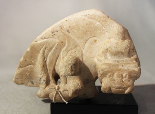 Lot 301 - A Chinese white marble aureole fragment with apsara, perhaps Northern Wei Dynasty