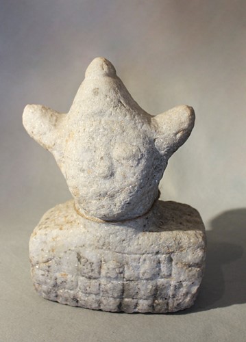 Lot 305 - A Chinese crystalline white stone stylised head with tricorn headgear