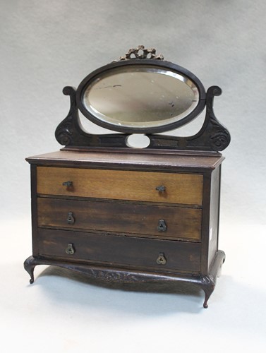 Lot 780 - An early 20th century manicure set contained within a miniature mahogany dressing chest