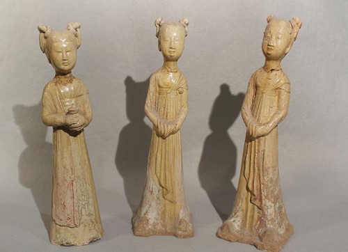 Lot 323 - Three Chinese straw glazed pottery standing slender tomb ladies, Sui Dynasty type