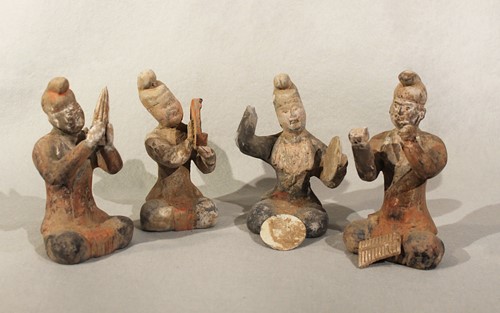 Lot 332 - A group of four Chinese painted pottery seated musicians, perhaps Tang Dynasty