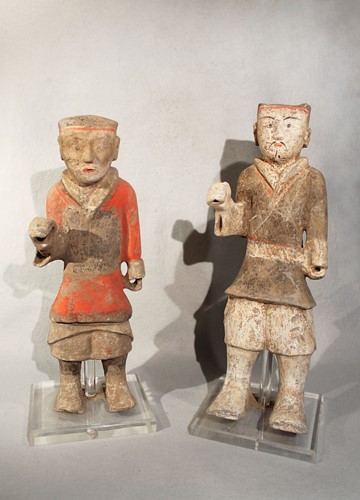 Lot 333 - Two Chinese painted pottery standing attendants/guards, perhaps Han Dynasty