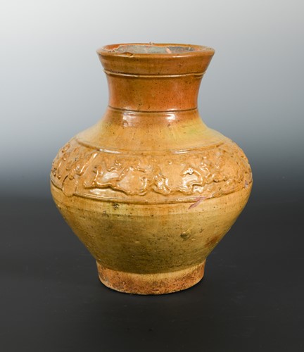 Lot 345 - A Chinese mustard glazed pottery vase with moulded "animals" girdle band, Han/Warring States