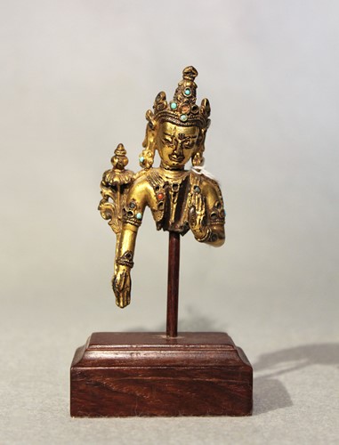 Lot 382 - A Tibetan gilt bronze Bodhisattva fragment, 14th/15th century