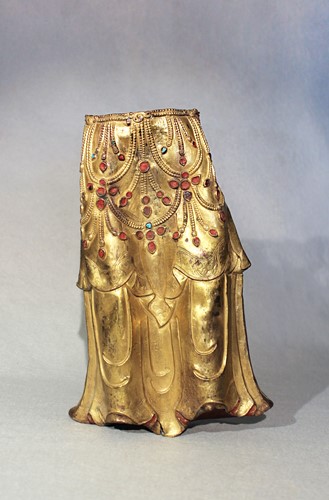 Lot 384 - A Tibetan gilt-copper lower torso fragment of a deity, 18th century