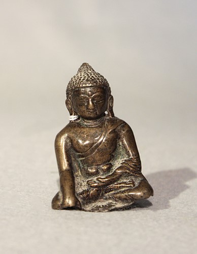 Lot 391 - A Tibetan bronze fragmentary small Buddha, seated in meditation, 16th century or later