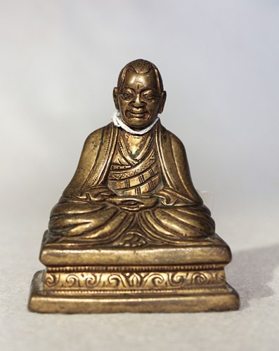 Lot 395 - A Tibetan gilt bronze seated Monk, 19th century or possibly earlier