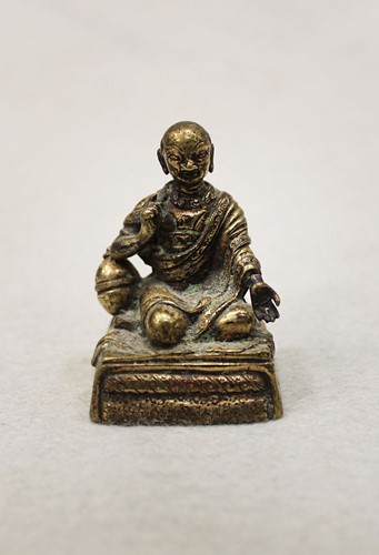 Lot 397 - A Sino-Tibetan Silvered bronze small seated figure of a Monk, circa 1800