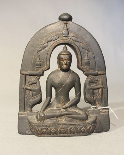 Lot 400 - A Nepalese black polished stone seated Buddha with arched aureole, probably 20th century