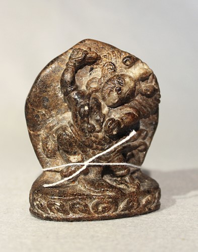 Lot 405 - A Tibetan mottled stone figure of Vajrapani, possibly 13th century