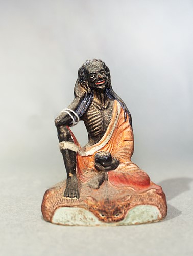 Lot 408 - A Tibetan painted plaster figure of Milarepa fasting, 19th century