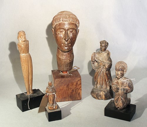Lot 412 - A group of five Philippines carved wood figures and heads of saints, 19/20th century