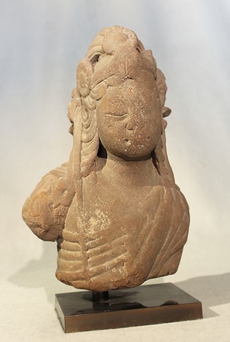 Lot 416 - An Indian carved pink sandstone fragmentary head and upper torso of Shiva, perhaps 13/14th century or later