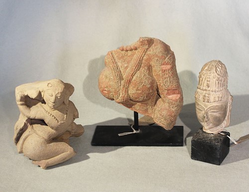 Lot 417 - A group of three Indian pink and cream coloured stone Shiva fragments, 13th/14th century style