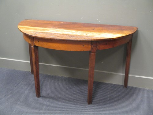 Lot 506 - A continental rustic demi-lune fruitwood table,...