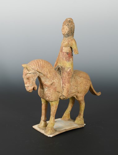 Lot 81 - A Chinese painted pottery horse with Middle Eastern lady rider up