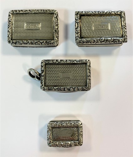 Lot 262 - A collection of four George IV silver miniature vinaigrettes