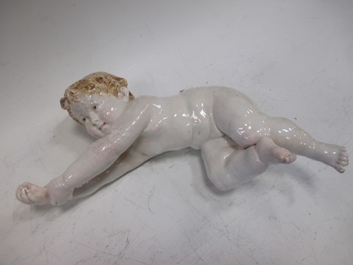 Lot 116 - A continental porcelain model of a cherub,...