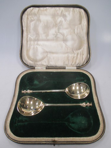 Lot 173 - A pair of silver gilt serving spoons - cased