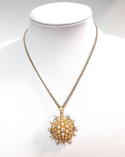 Lot 129 - A late Victorian split pearl and diamond star pendant/brooch and chain