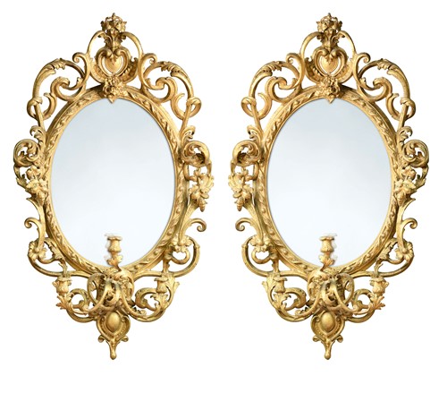 Lot 233 - A pair of carved giltwood and gesso three light girandoles, circa 1875