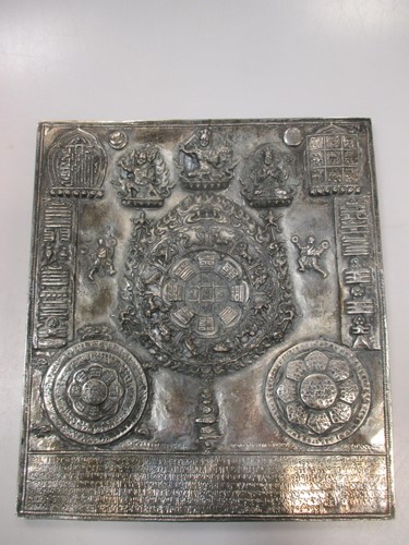 Lot 171 - A Nepalese silver cased relief plaque,...