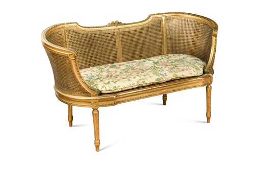 Lot 308 - A giltwood and gold-painted cane small canapé of Louis XVI style
