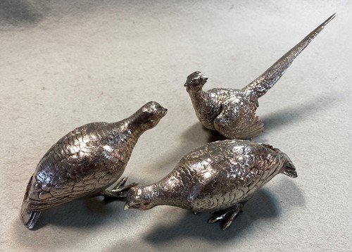Lot 275 - A brace of 20th century cast silver grouse together with a cast silver cock pheasant