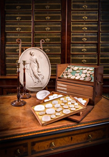 Lot 222 - A large collection of Grand Tour plaster relief cameos and plaques, 19th century
