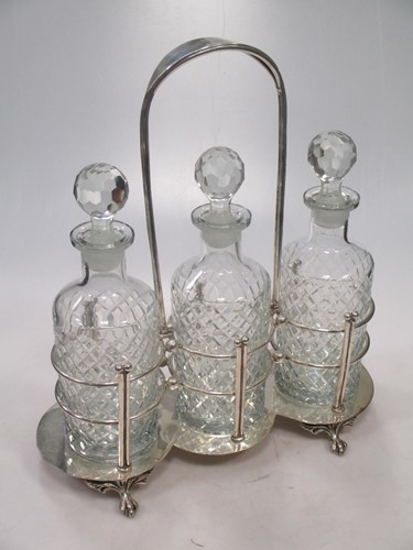 Lot 168 - A silver plated three bottle decanter stand,...