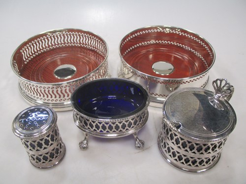 Lot 170 - Two silver bottle coasters and a silver three...