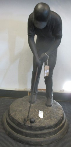 Lot 129 - A cast iron figure of a golfer putting, on...