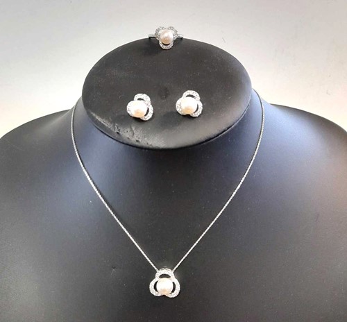 Lot 124 - A three piece suite of pearl and diamond jewellery