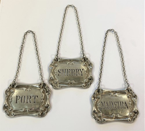 Lot 266 - A trio of Edward VII silver decanter labels