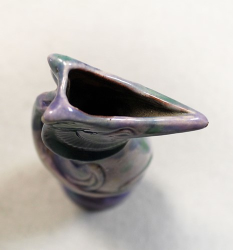 Lot 23 - Attributed to Brannam Pottery, a small grotesque Jug