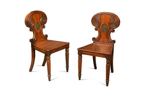 Lot 312 - A pair of late Regency mahogany armorial hall chairs