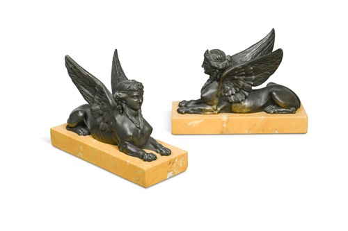 Lot 317 - A pair of Regency style bronzed model sphinxes