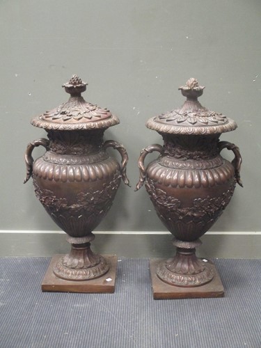 Lot 418 - A pair of modern reproduction bronze urns with...