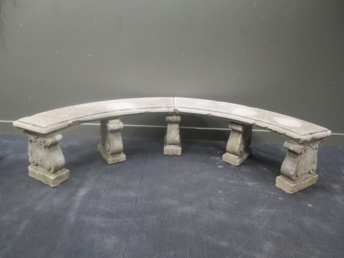 Lot 431 - A semicircular composite garden bench on five...