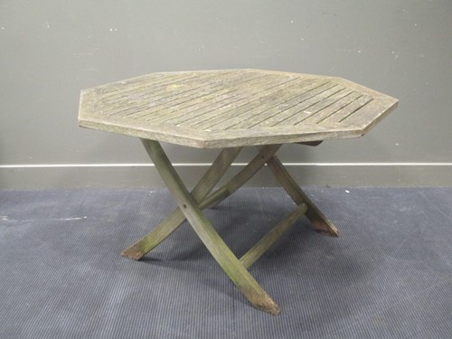 Lot 428 - An octagonal wooden garden table 122cm