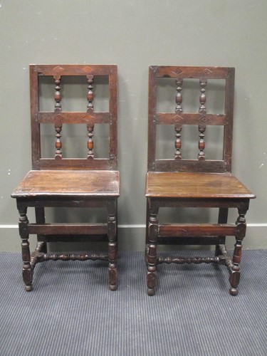 Lot 305 - A pair of upright panel chairs in 17th century...