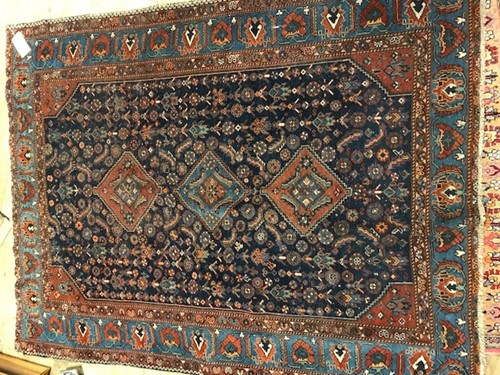 Lot 651 - A dark blue ground rug with 3 central lozenges,...