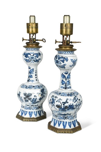 Lot 187 - A pair of Delft blue and white gilt metal mounted lamps