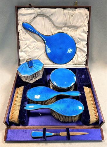 Lot 296 - A George V silver and enamel 7 piece dressing table set with one addition