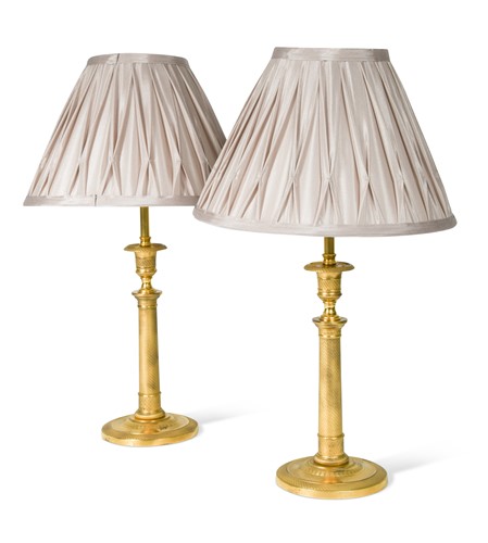 Lot 307 - A pair of Regency engine turned ormolu candlestick lamps, circa 1820