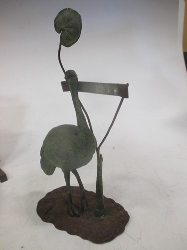 Lot 33 - A patinated metal menu holder modelled as an...